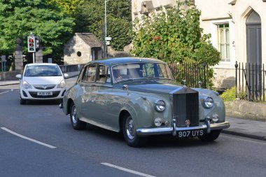A Rolls Royce Silver Cloud drive along a town centre street on September 22, 2016 in Bradford on Avon, UK.