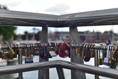 Bristol, UK - October 10, 2016: Padlocks hang from a bridge in the town centre. Known as  love locks the practice began in Europe and has spread worldwide.