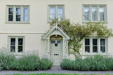 View of front door of old town house on a street in an English town