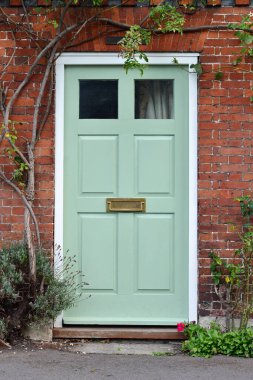 View of front door of old town house on a street in an English town