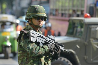 An armed Thai soldier stands guard on a street during an anti coup rally on May 25, 2014 in Bangkok, Thailand. Thailand has seen 20 coup d'etat and attempted coups since 1912.