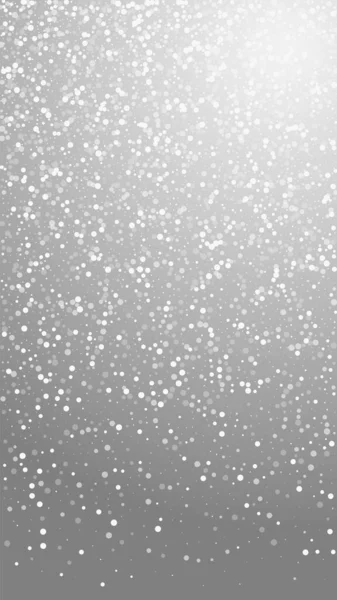 ランダムな白い点クリスマスの背景 灰色の背景に小さな飛行雪のフレークと星 冬の銀雪の結晶オーバーレイテンプレートをアピールする 一般的でない縦図 — ストックベクタ