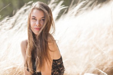 Açık havada genç ve güzel bir kadının yakın plan portresi. Tarafsız arka planda çekici bir kadın..