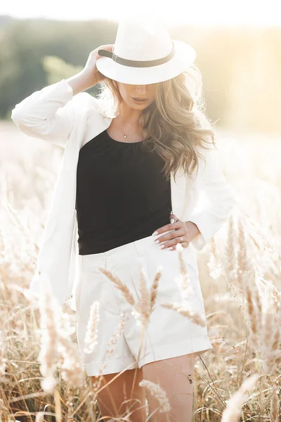 Şapkalı genç ve çekici bir kadın. Açık havada güzel bir kadının yakın plan portresi. Güzel bayan gülümsüyor