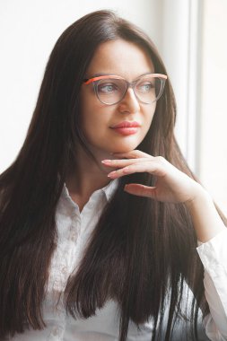 Closeup portrait of young lady indoors. Woman in cafeteria. Attractive brunette woman.