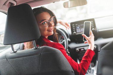 Attractive brunette in the car. Lady driving.