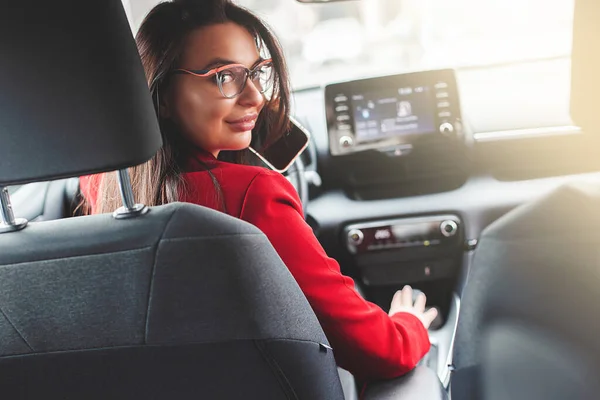 Attractive brunette in the car. Lady driving.