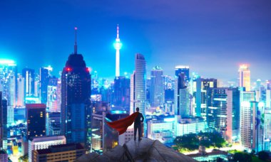 Businessman in suit and cape hero stand at top looking great cityscape view and thinking business plan of the future . Night scene .