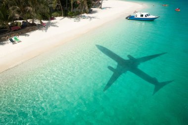 Beautiful tropical beach with airplane shadow. Travel concep