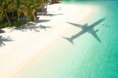 Beautiful tropical beach with airplane shadow. Travel concept