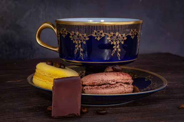 vintage crockery and macaroon with chocolate pieces and coffee beans. High quality photo