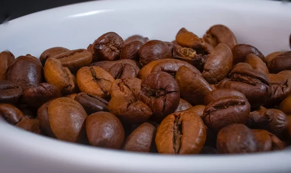 coffee beans in a white bowl. High quality photo