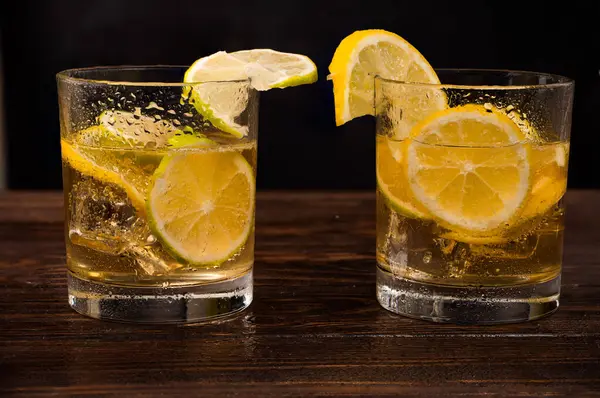lemonade with lemon slices on wooden background. High quality photo