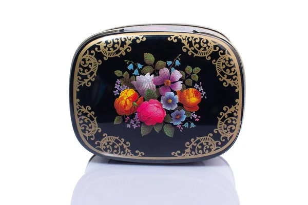 metal box with flowers pattern isolated on white background. High quality photo