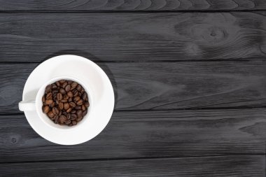  roasted coffee beans in white cups. demonstrating free copy space for your text or design. High quality photo