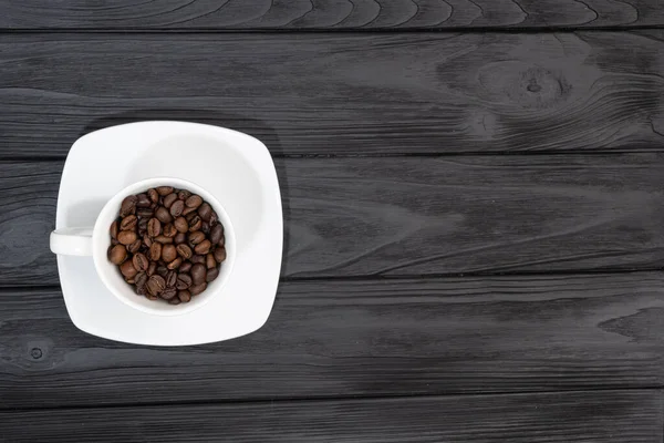  roasted coffee beans in white cups. demonstrating free copy space for your text or design. High quality photo