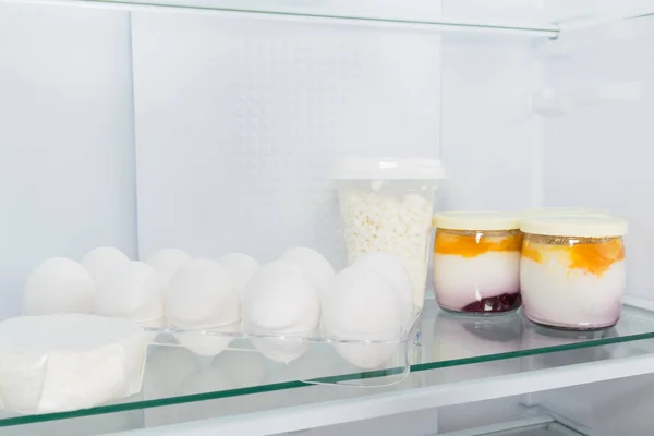 farm organic dairy products on the shelf in the refrigerator, close-up