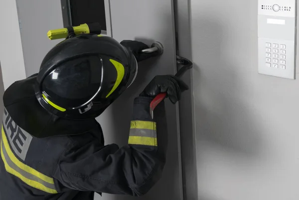 Firefighter Trying Open Iron Entrance Door Entrance Crowbar Close Place — Stock Photo, Image