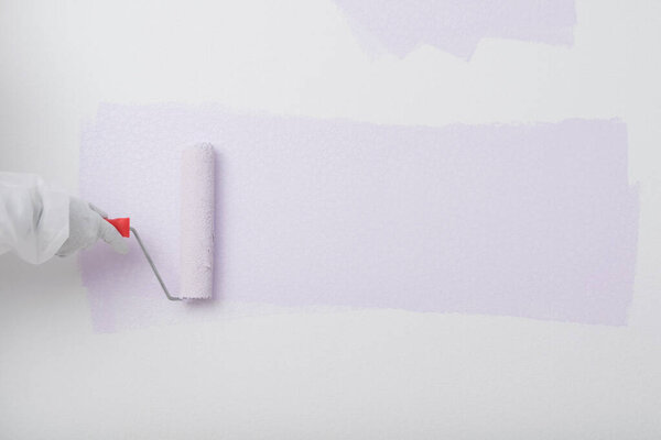roller painted a purple stripe on a white wall
