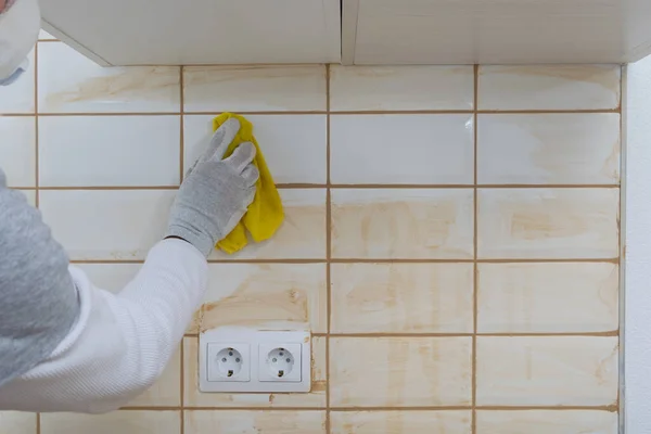 the builder wipes the remains of the grout from the tile surface, there is a place for the inscription