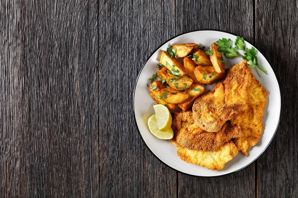 Breaded Chicken Cutlets Oven Roasted Potato Wedges Plate Wooden Table — Stock Photo, Image