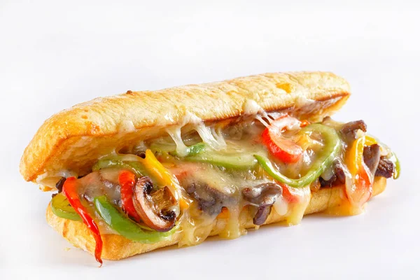 philadelphia cheese steak sandwich with roasted beef, pepper, caramelized onion, mushrooms and melted cheese on a white background, close-up