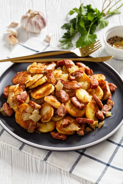 Bratkartoffeln Fried Potatoes Bacon Onion Plate Cutlery White Wooden Table — стоковое фото