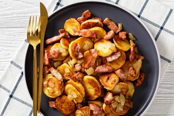 Bratkartoffeln Fried Potatoes Bacon Onion Plate Cutlery White Wooden Table — ストック写真