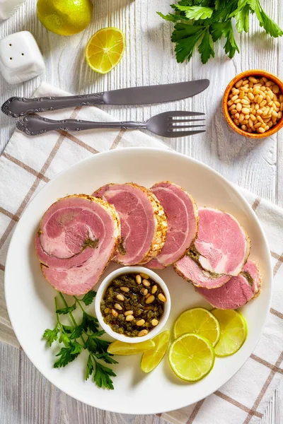 Italian Garlic Herb Stuffed Rolled Pork Tenderloin Slices Plate Sauce — стоковое фото