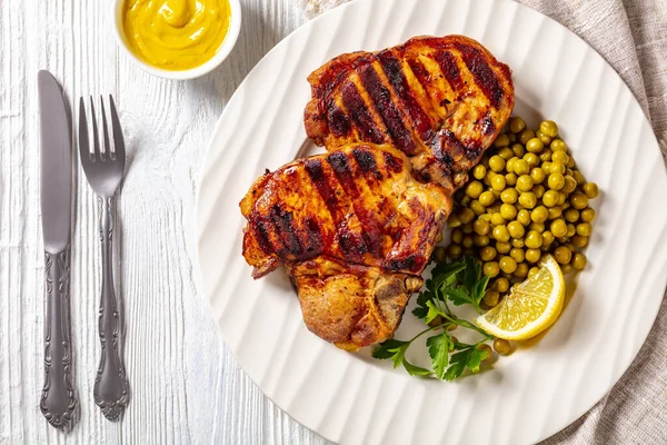 Bifes Carne Porco Grelhados Com Ervilhas Verdes Cozidas Limão Uma — Fotografia de Stock