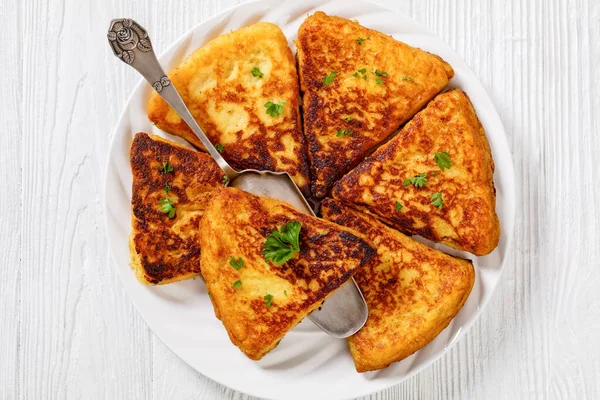 Potato Farls, Irish Potato Cakes, potato bread on white plate on white wooden table, flat lay, close-up