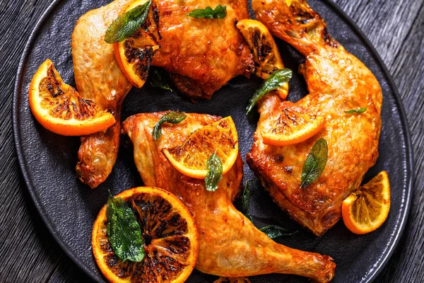 Close Orange Barbecue Grilled Chicken Black Plate Sage Leaves Horizontal — Zdjęcie stockowe