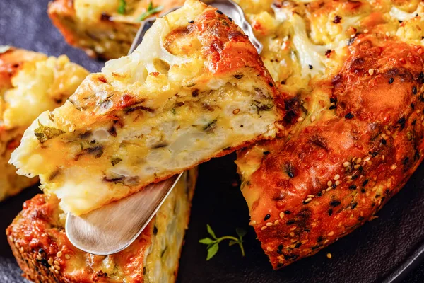 Close Slice Cauliflower Cake Parmesan Cheese Basil Spices Sliced Black — стоковое фото