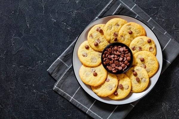 chocolate chip lemon yellow cookies on  plate on grey table, american cuisine, horizontal view from above, flat lay