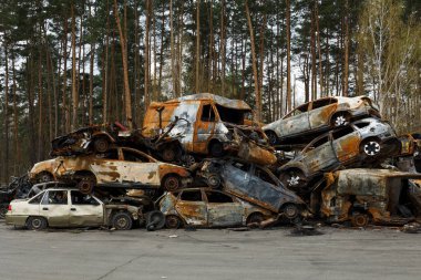 Irpin UKRAINE APR 25 2022  Dump of civilian cars stolen by the Russian army and destroyed during Russia's war against Ukraine clipart