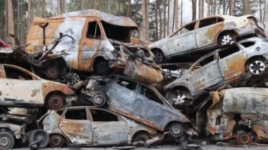 Irpin, UKRAINE APR 25 2022  Dump of burnt civilian cars stolen, shoot by the Russian army and destroyed during Russia's war against Ukraine