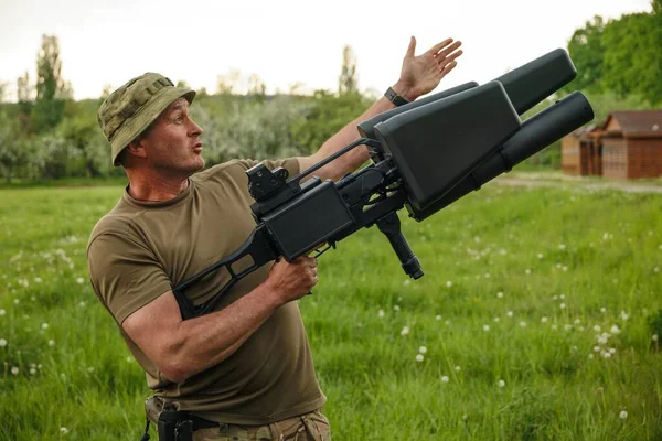 Stock image KYIV, UKRAINE Ukrainian militaries testing portable antidrone jammer (counter drone rifle) EDMS, long-range electronic gun for combating multicopter, MAY 14, 2022