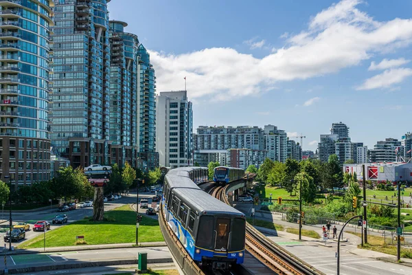VANCOUVER, CANADA - JULY 18, 2020: skytrain running through tall buildings in center of city of vancouver Royalty Free Stock Photos