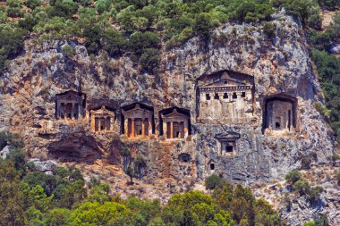 Famous rock-cut Lycian tombs of kings in carved caves in the cliffs of ancient Caunos (Kaunos) town, a UNESCO world heritage site at Dalyan, Mugla, Turkey.