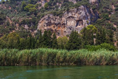 Famous rock-cut Lycian tombs of kings in carved caves in the cliffs of ancient Caunos (Kaunos) town, a UNESCO world heritage site at Dalyan, Mugla, Turkey.