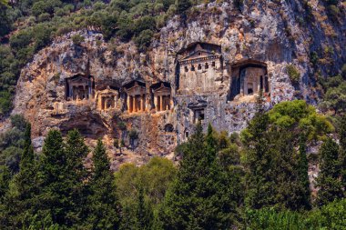 Famous rock-cut Lycian tombs of kings in carved caves in the cliffs of ancient Caunos (Kaunos) town, a UNESCO world heritage site at Dalyan, Mugla, Turkey.