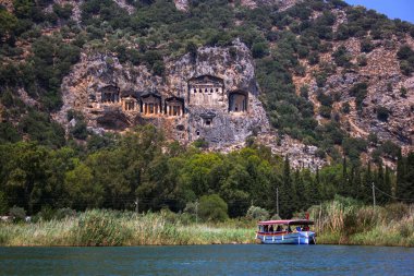 Famous rock-cut Lycian tombs of kings in carved caves in the cliffs of ancient Caunos (Kaunos) town, a UNESCO world heritage site at Dalyan, Mugla, Turkey.
