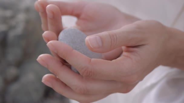 Female hands holding and pebble stone. — Video Stock
