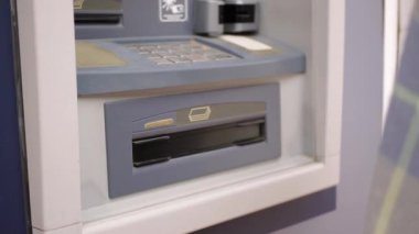 Para kazanmak için ATM kullanan bir kadın..