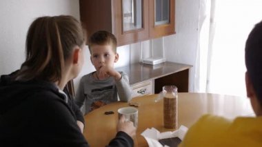 Family having a breakfast snack at home