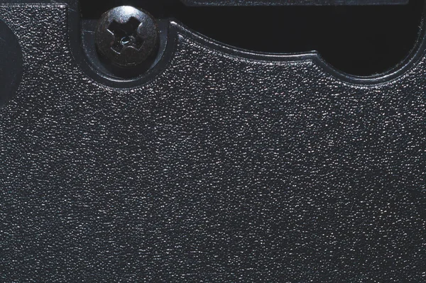 Vidalı siyah plastik yüzey. Plastik kasetin detaylarını kapat