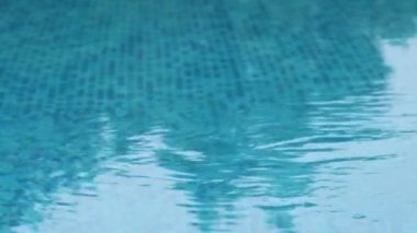 Surface of blue swimming pool. Wavy water surface of swimming pool.