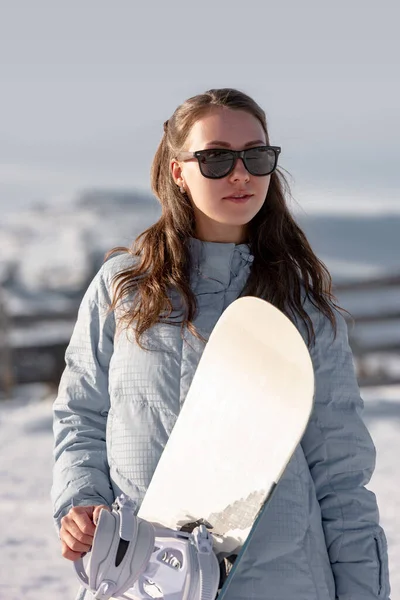 Портрет дівчини-любителя сноубордиста зі сноубордом — стокове фото