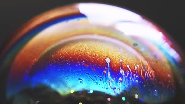 Abstract pattern, rainbow chaotic texture inside of the soap bubble, closeup — Stock Video