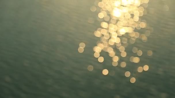 Abstract motion of the sunset sea, shimmering water defocused background, bokeh effect — Vídeo de Stock